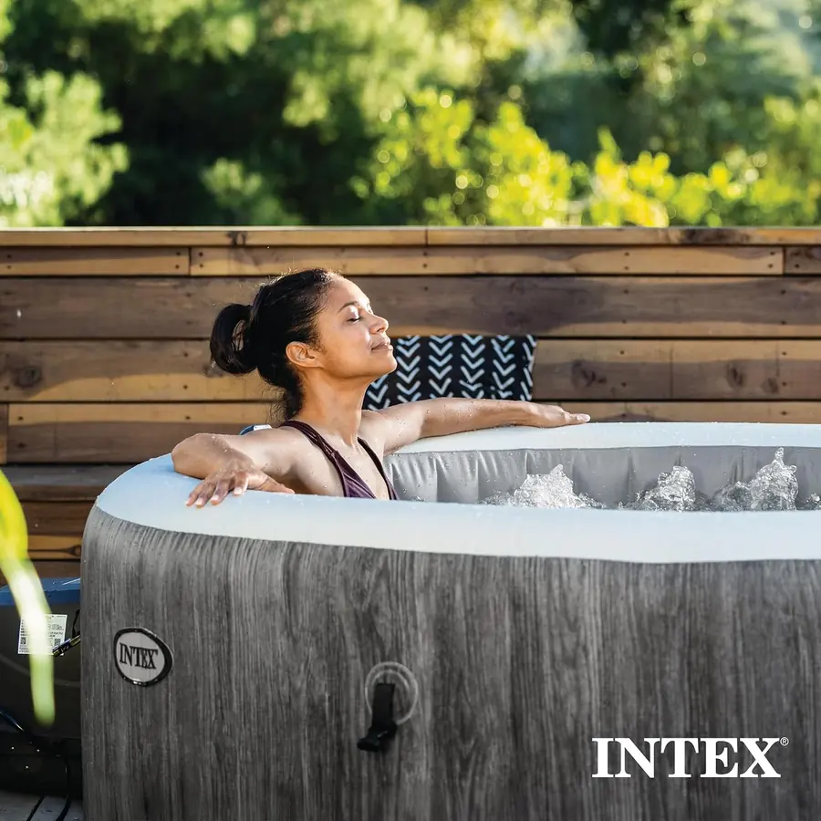 Woman leaning back against the rim of the PureSpa with the bubble jets running