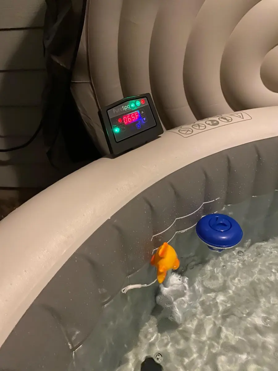 PureSpa control panel reading 105°F beside a floating chlorine dispenser